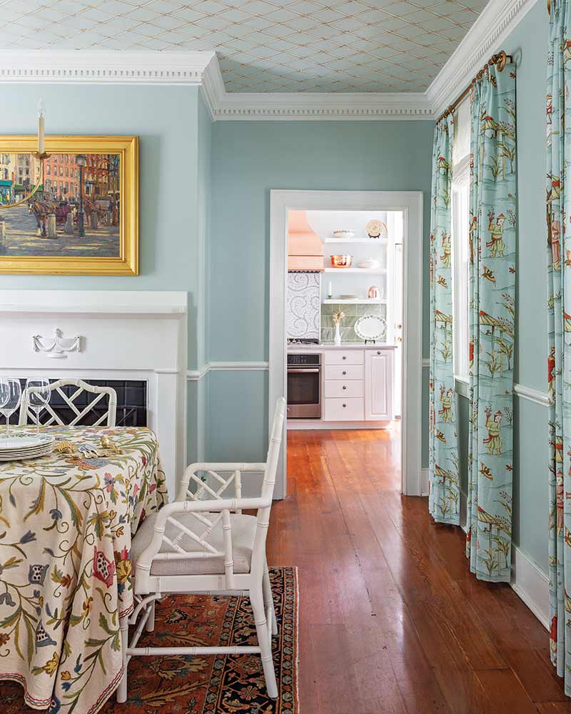 South Carolina Home - light blue dining room with floral curtains and table cloth, view into kitchen