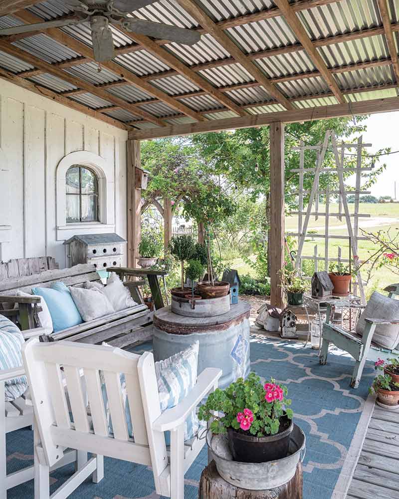 A covered porch with blue-and-white furnishings.