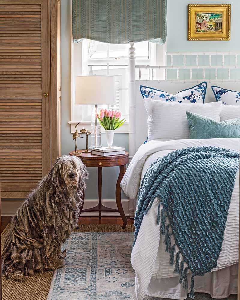 South Carolina Home - bedroom with white and blue covers and komondor dog nearby
