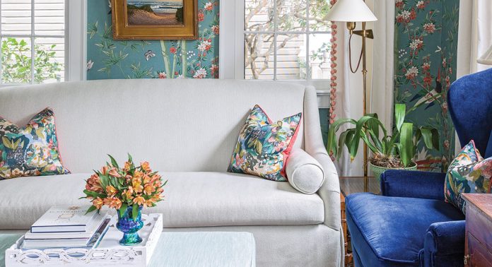 South Carolina Home - Living Room with floral wall paper, blue reading chair, white couch