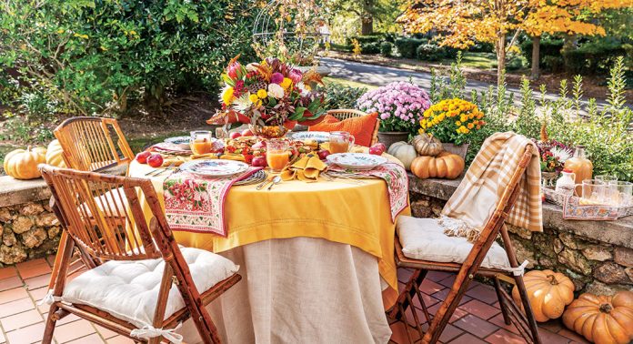 An alfresco tablescape with yellow, orange, and red accents.