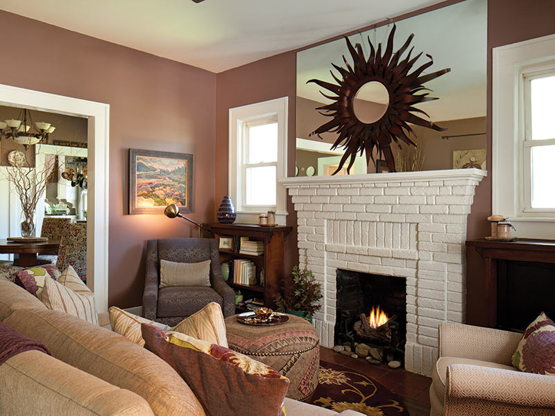 Cozy Living Room with fireplace, mirror over hearth with embossed sun